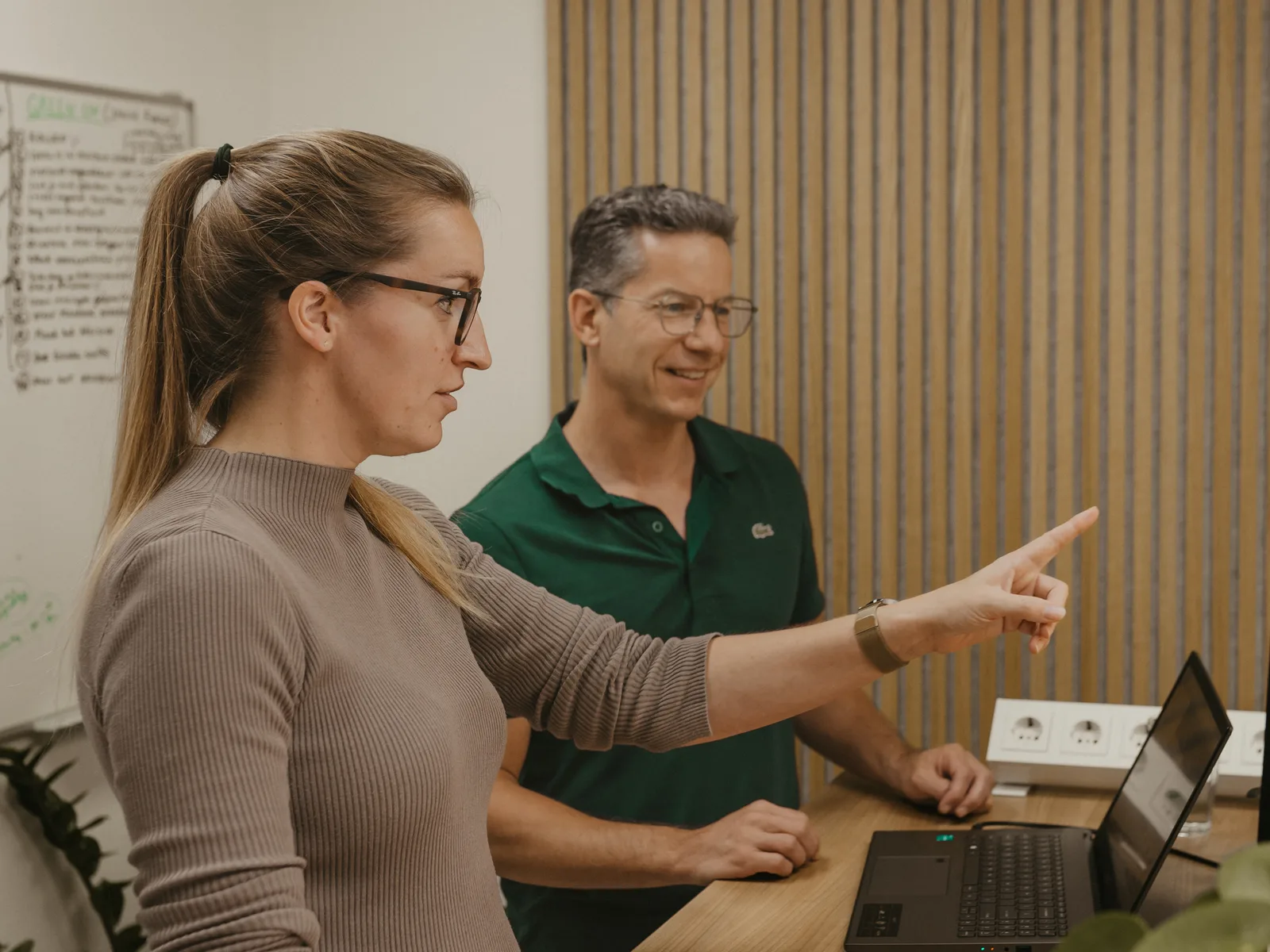 Simone pointing something out on screen during a meeting with a client